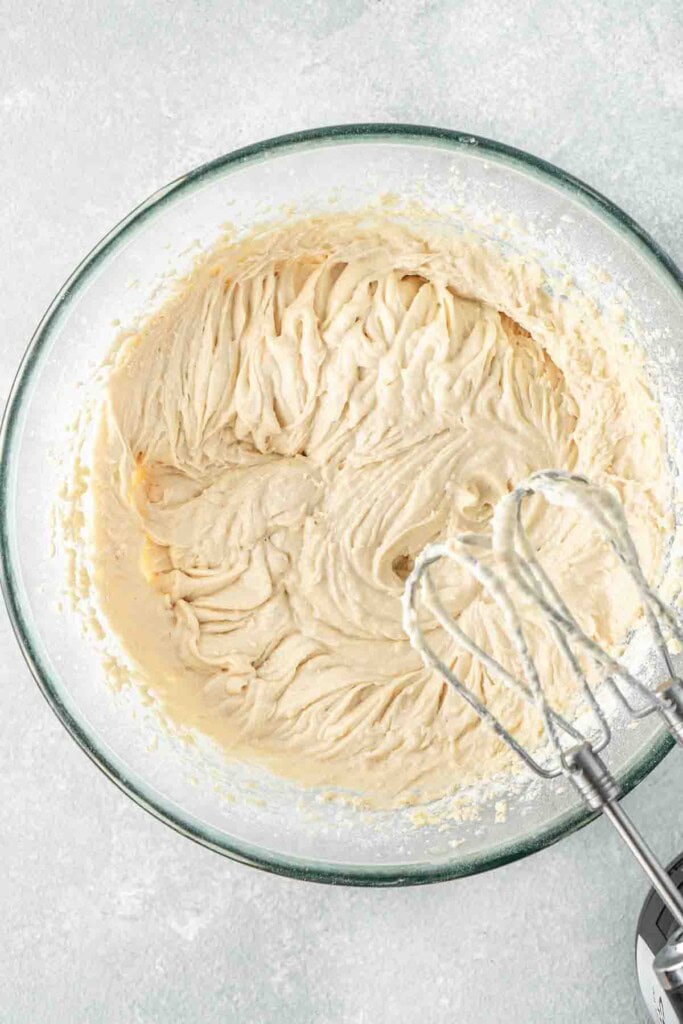 The creamy cupcake batter in a glass bowl.