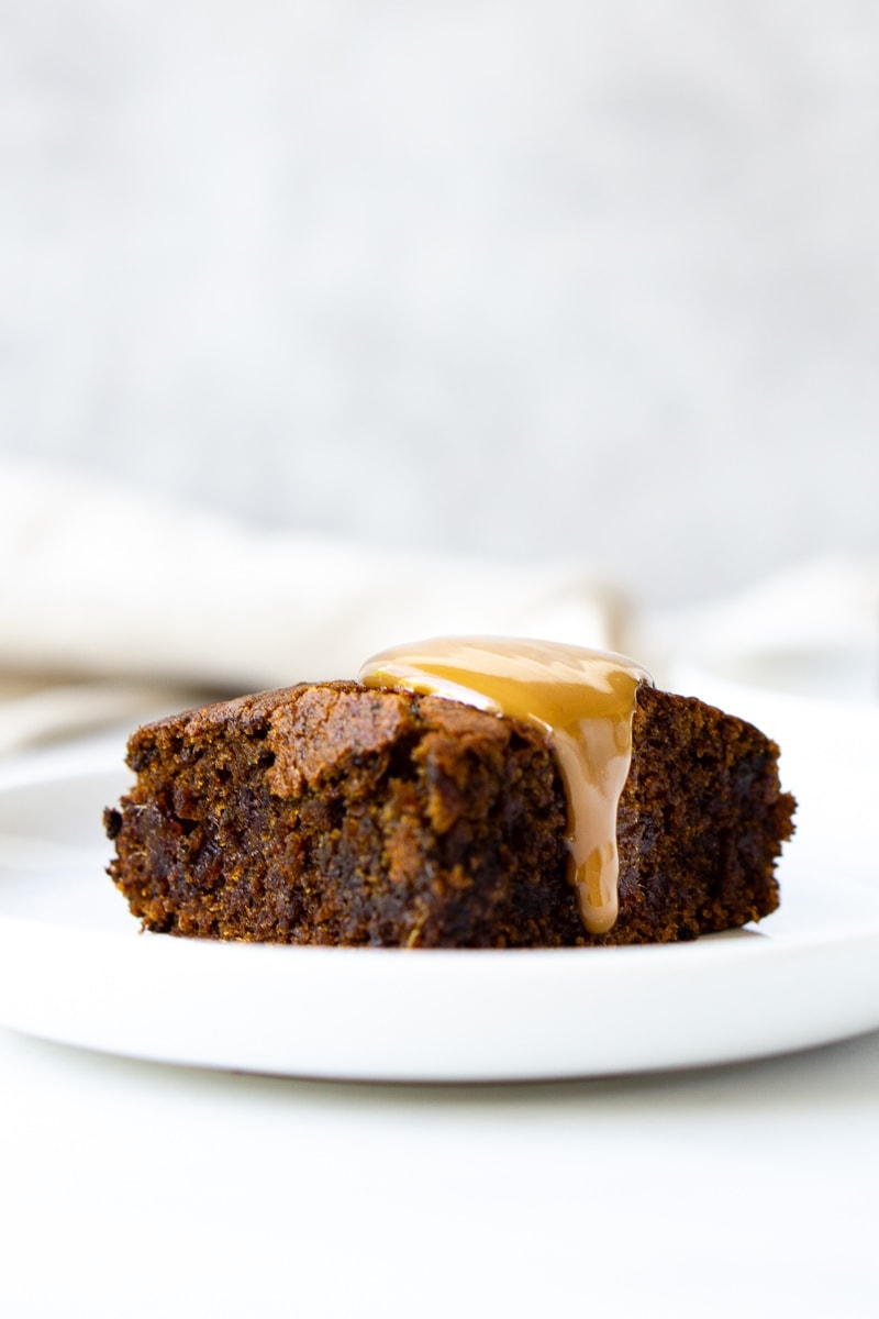 Slice of sticky date pudding with caramel sauce