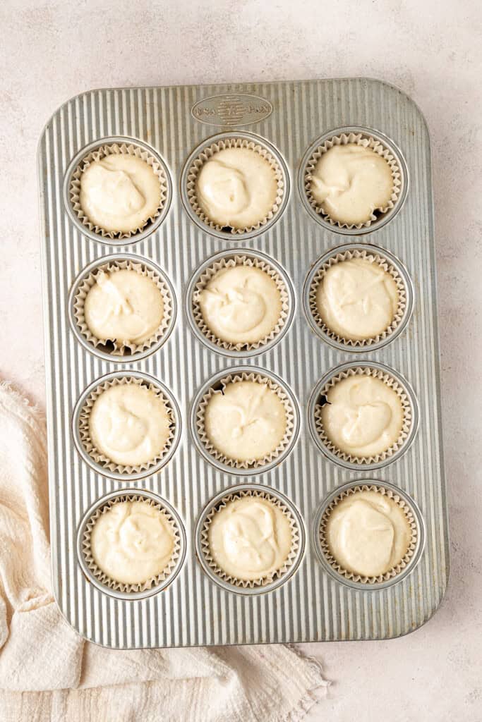 The gluten free lemon cupcake batter in a muffin tin ready to be baked.