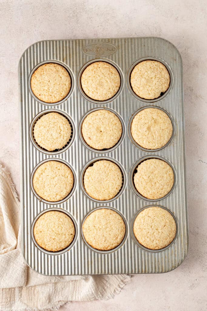 Cooked lemon cupcakes in a baking tin.