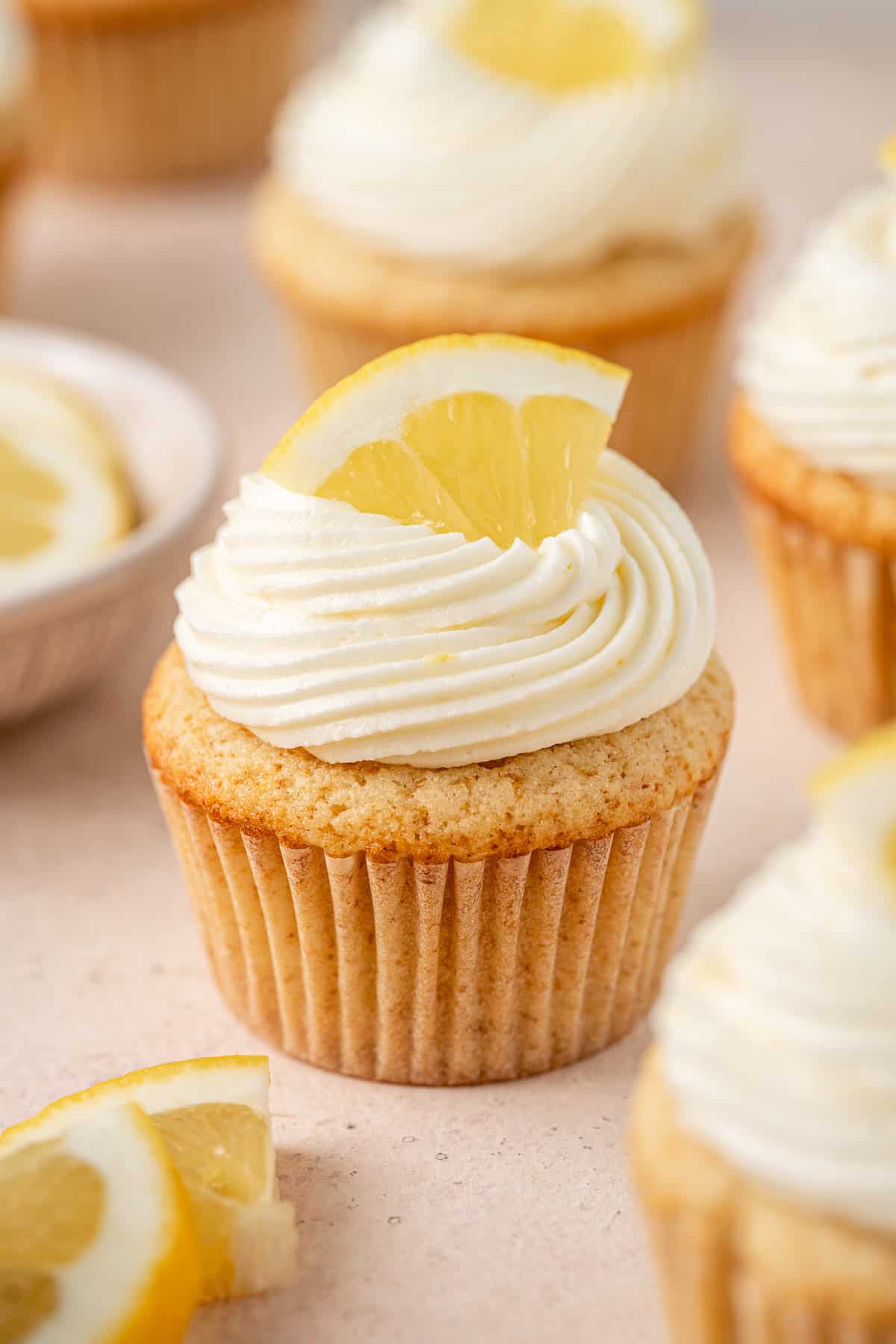 Close up of a gluten and dairy free lemon cupcake with buttercream frosting.