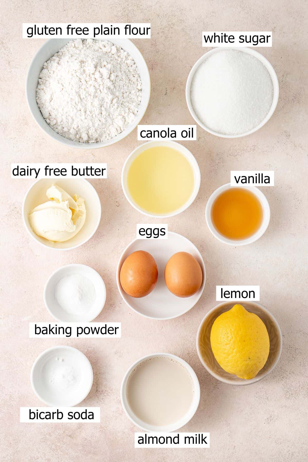 All ingredients needed to make gluten free lemon cupcakes laid out in bowls.