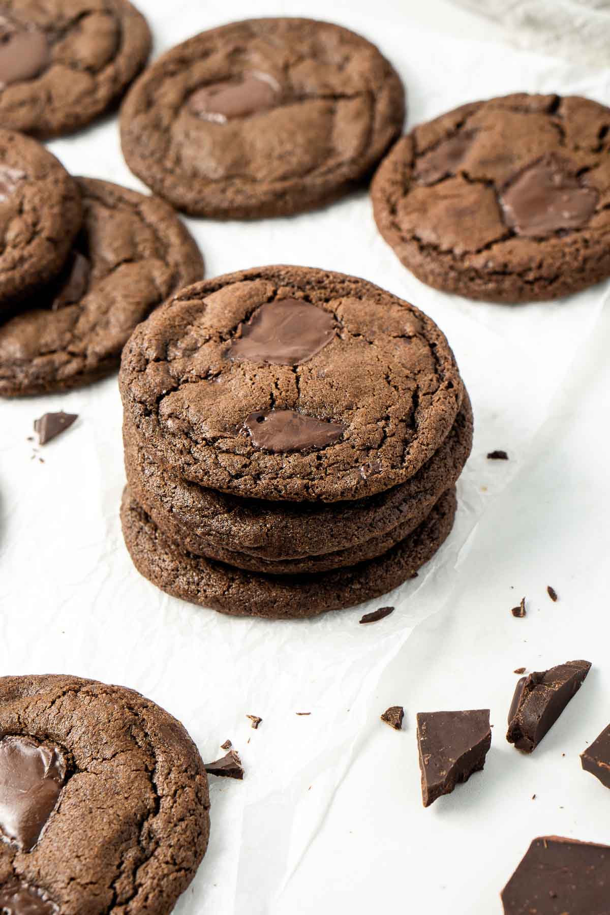 Four dairy free double chocolate cookies stacked on top of each other.