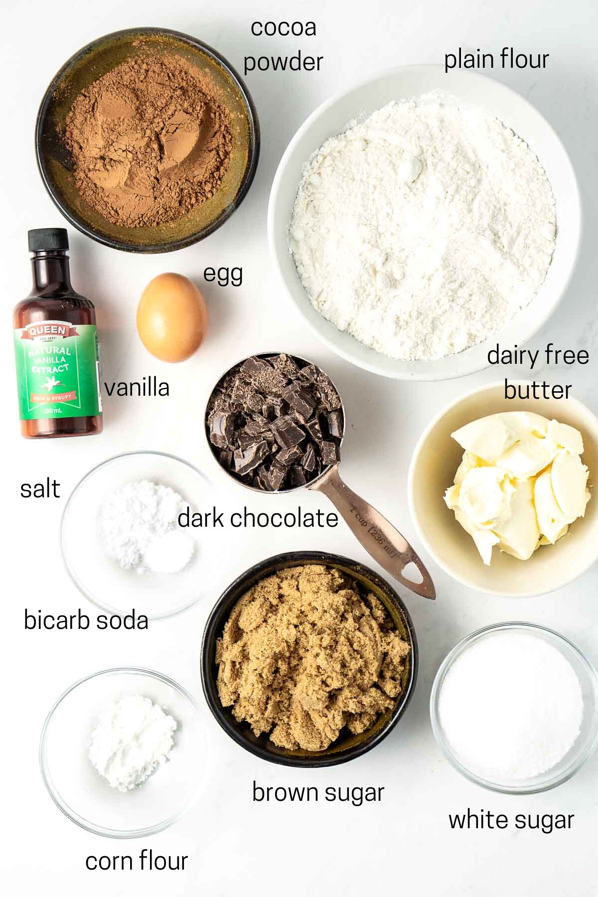 All ingredients needed for chocolate cookies laid out in small bowls.