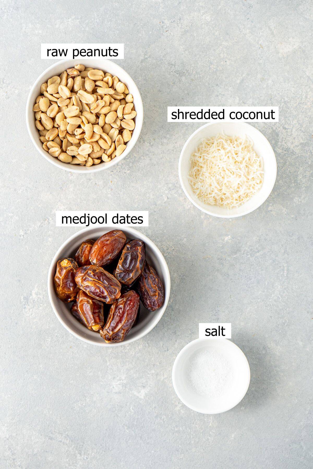 All ingredients needed to make peanut butter balls laid out in small bowls.
