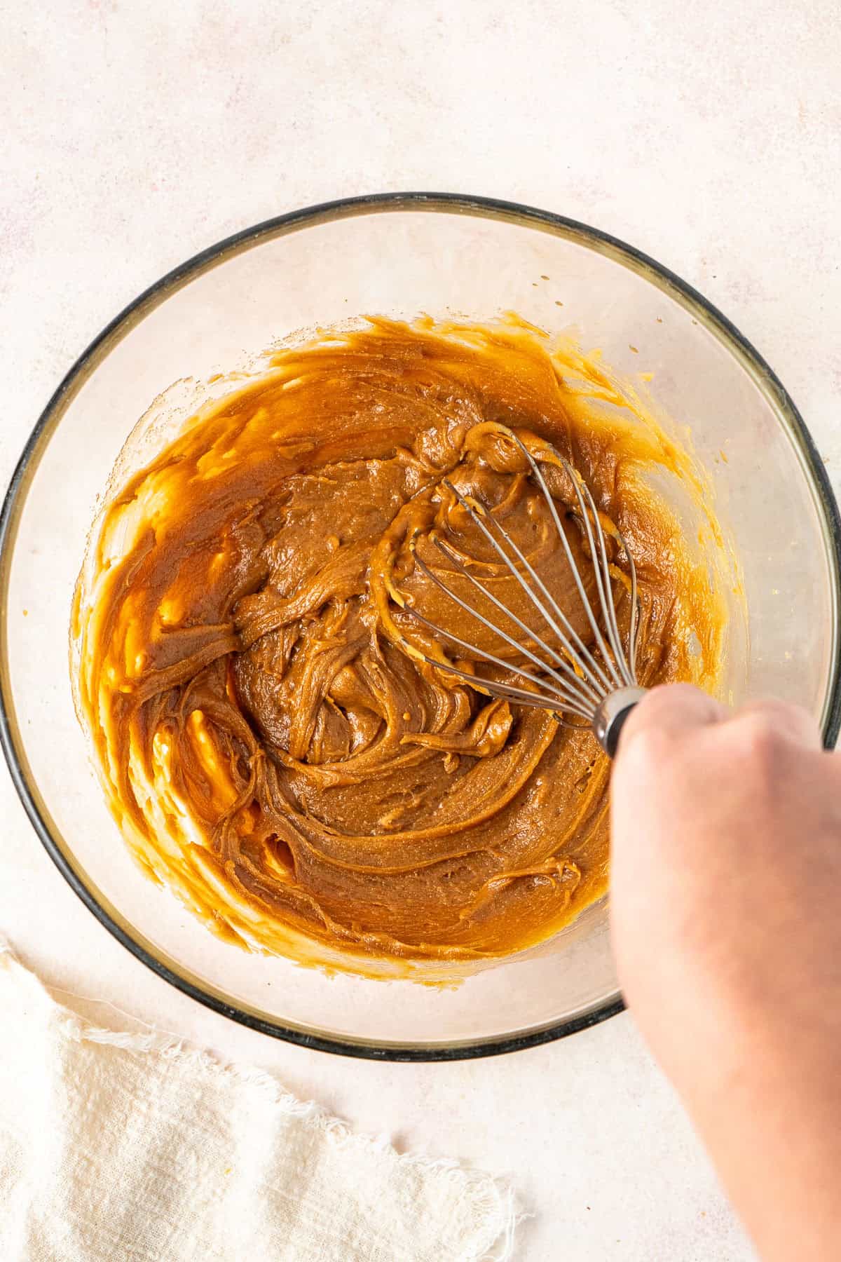 Whisking in the peanut butter into the bowl.