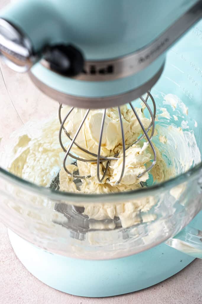 Beating together the butter and vanilla in a stand mixer.
