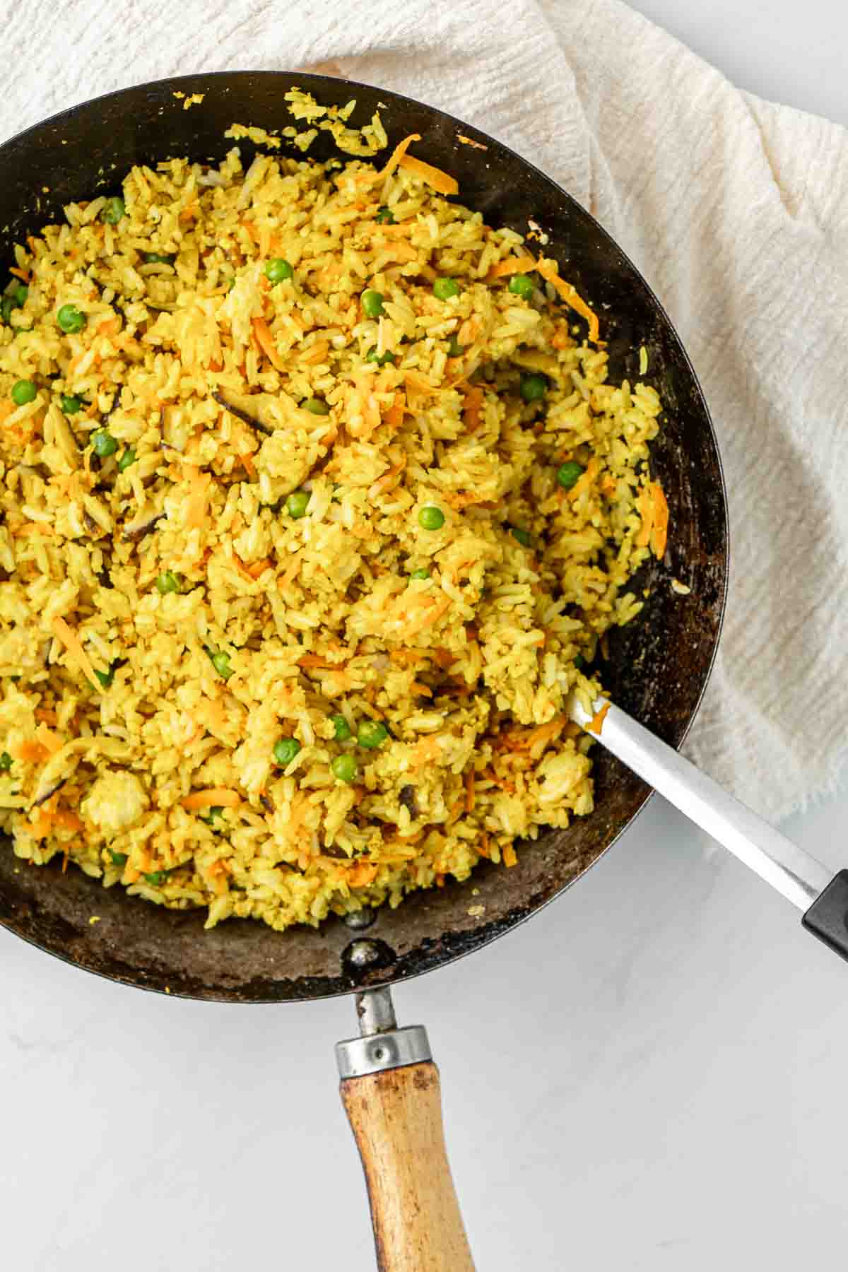 Close up of turmeric fried rice in a wok.