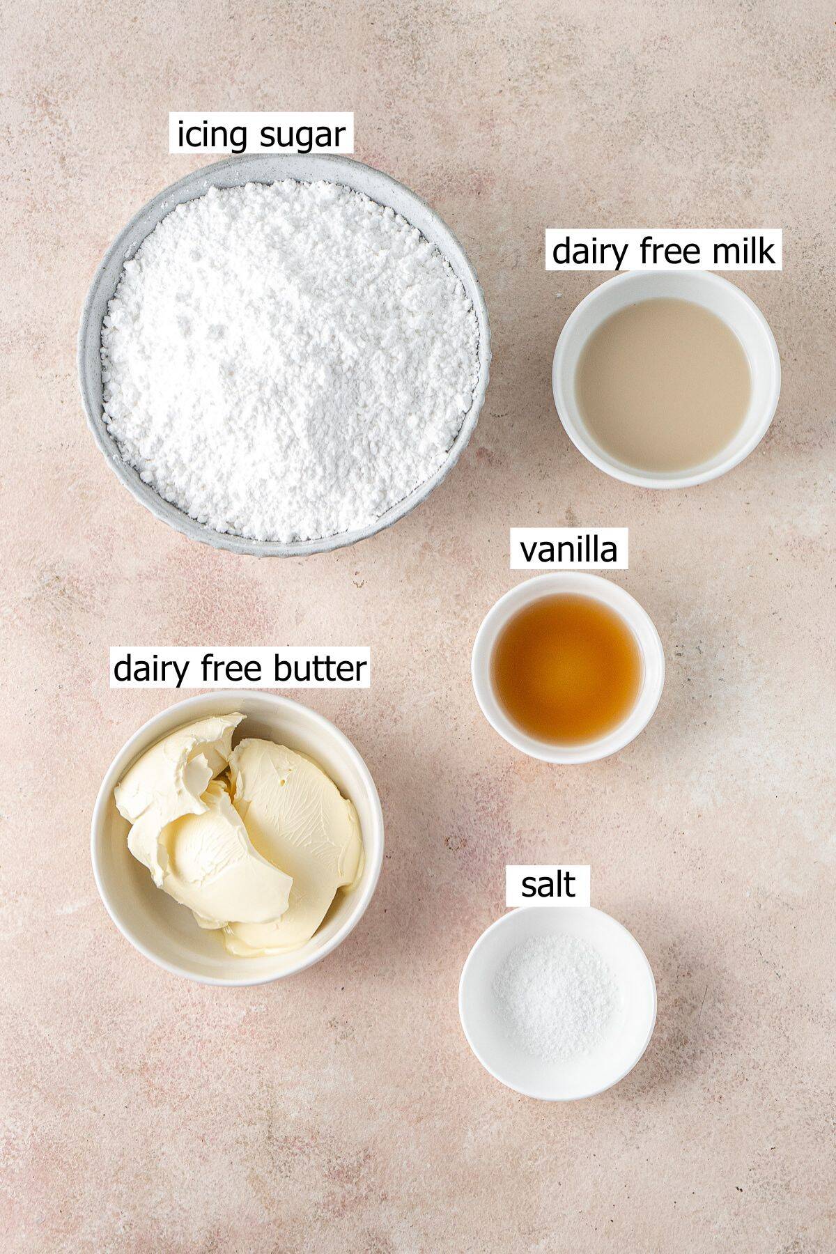 All ingredients needed to make vegan vanilla buttercream laid out in small bowls.