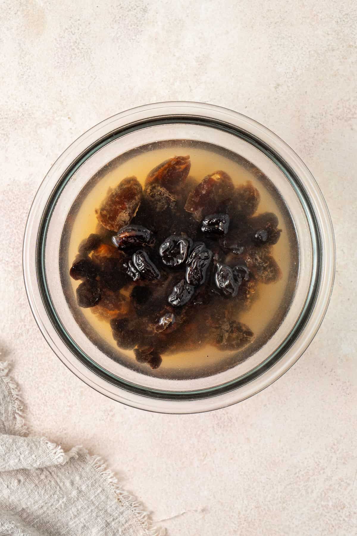 Soaking the dates and cherries in water.