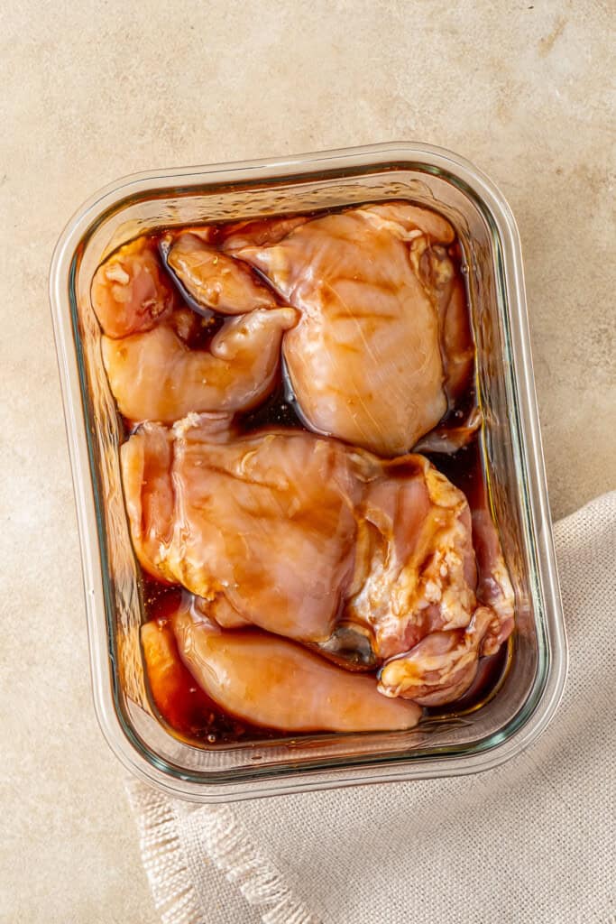 Marinating the chicken thighs in teriyaki sauce.