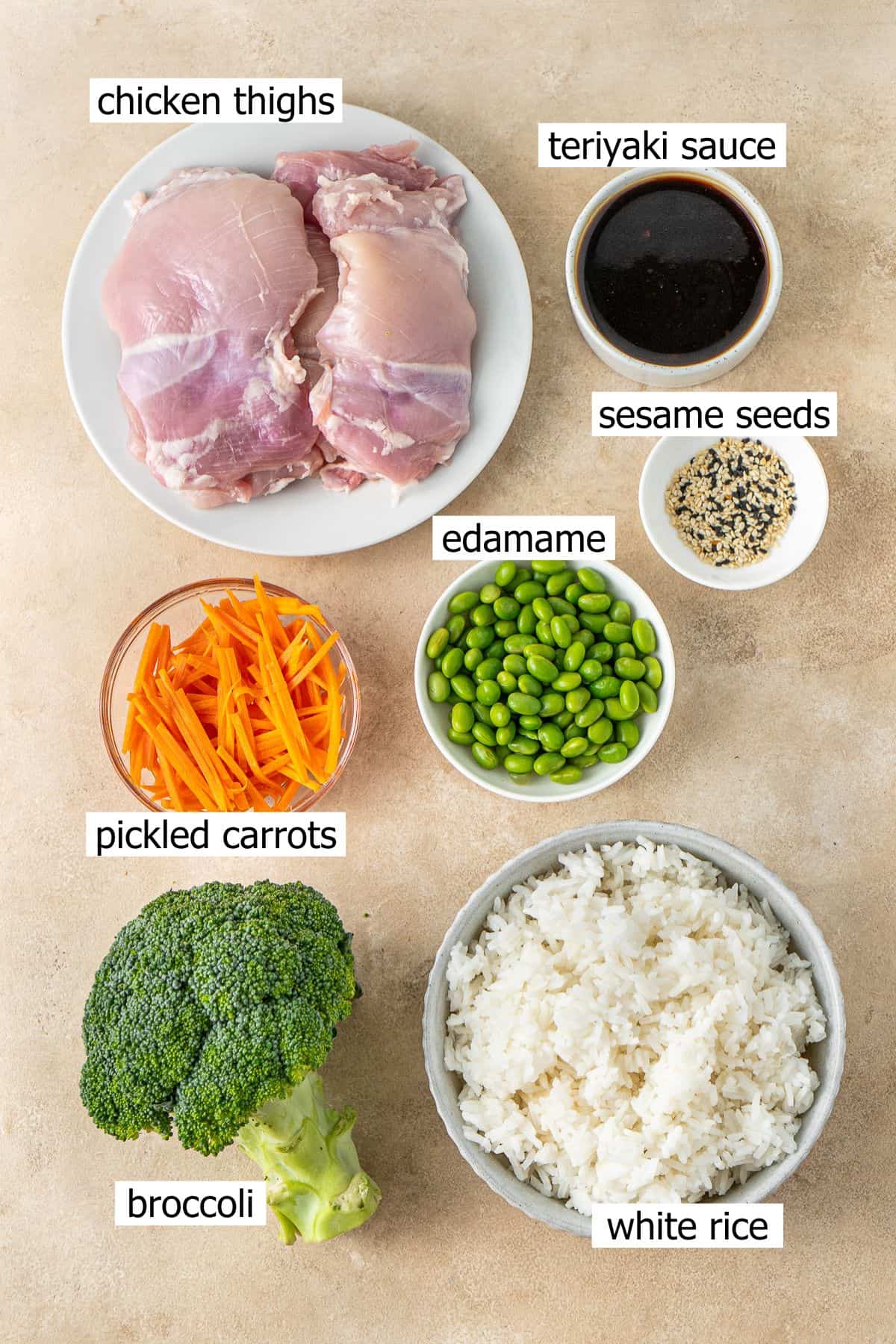 All ingredients needed to make teriyaki chicken bowls laid out in small bowls.