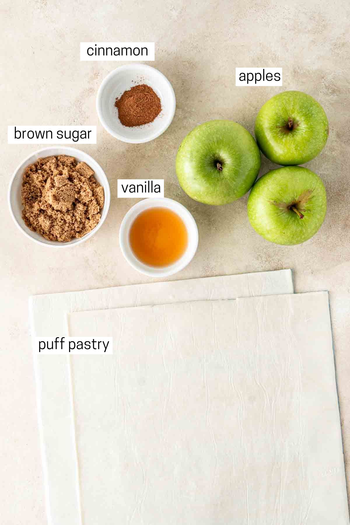 All ingredients needed to make apple turnovers laid out in bowls.