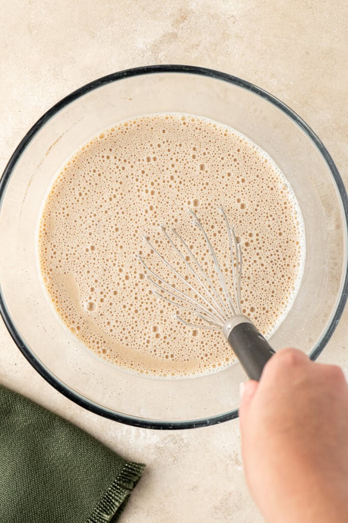 Whisking the egg mixture in a large bowl.