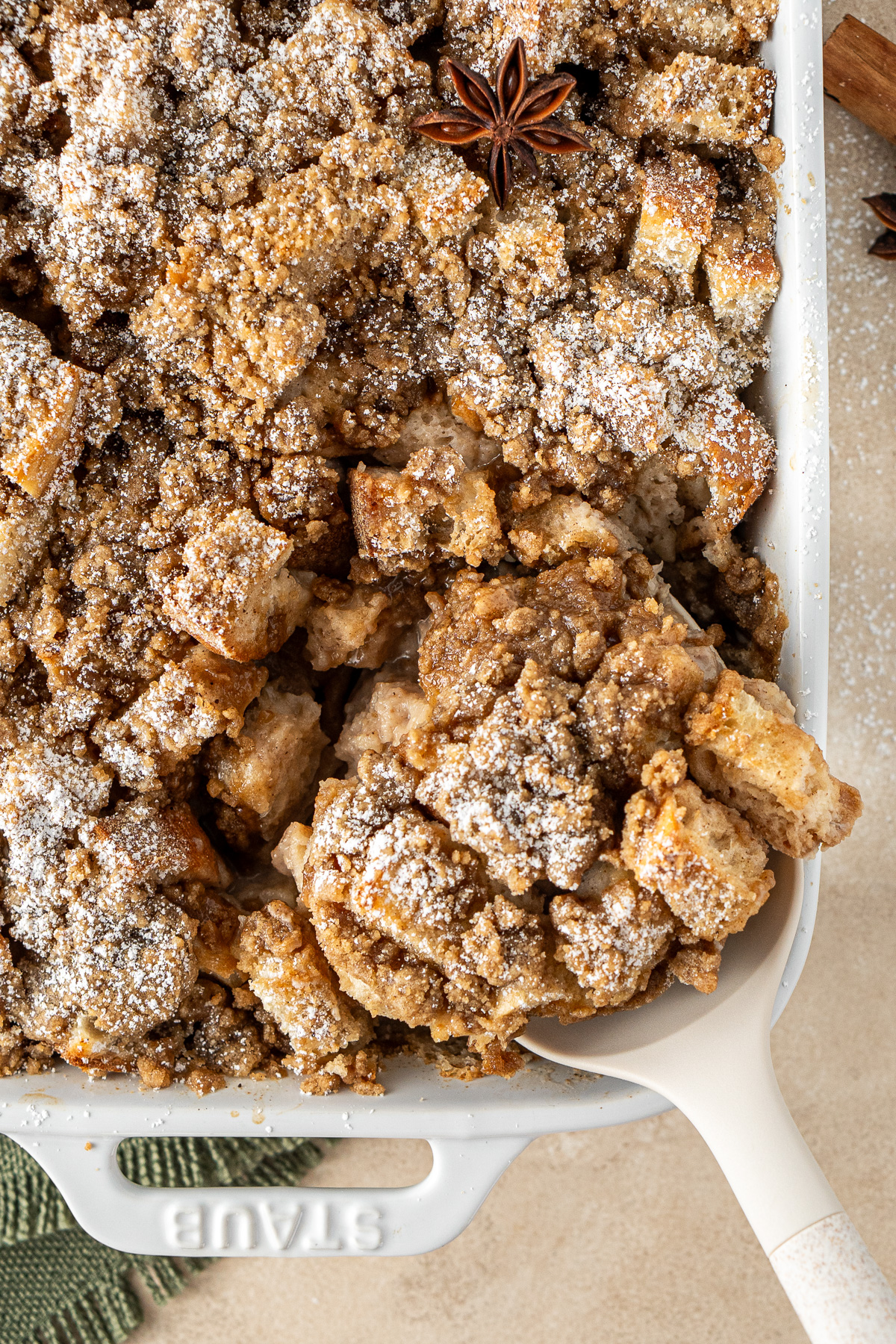 S spoon serving a slice of French toast casserole.