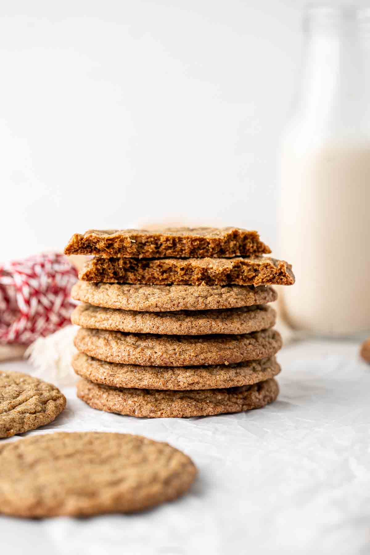 Stack of ginger snap biscuits with the top one broken in half.