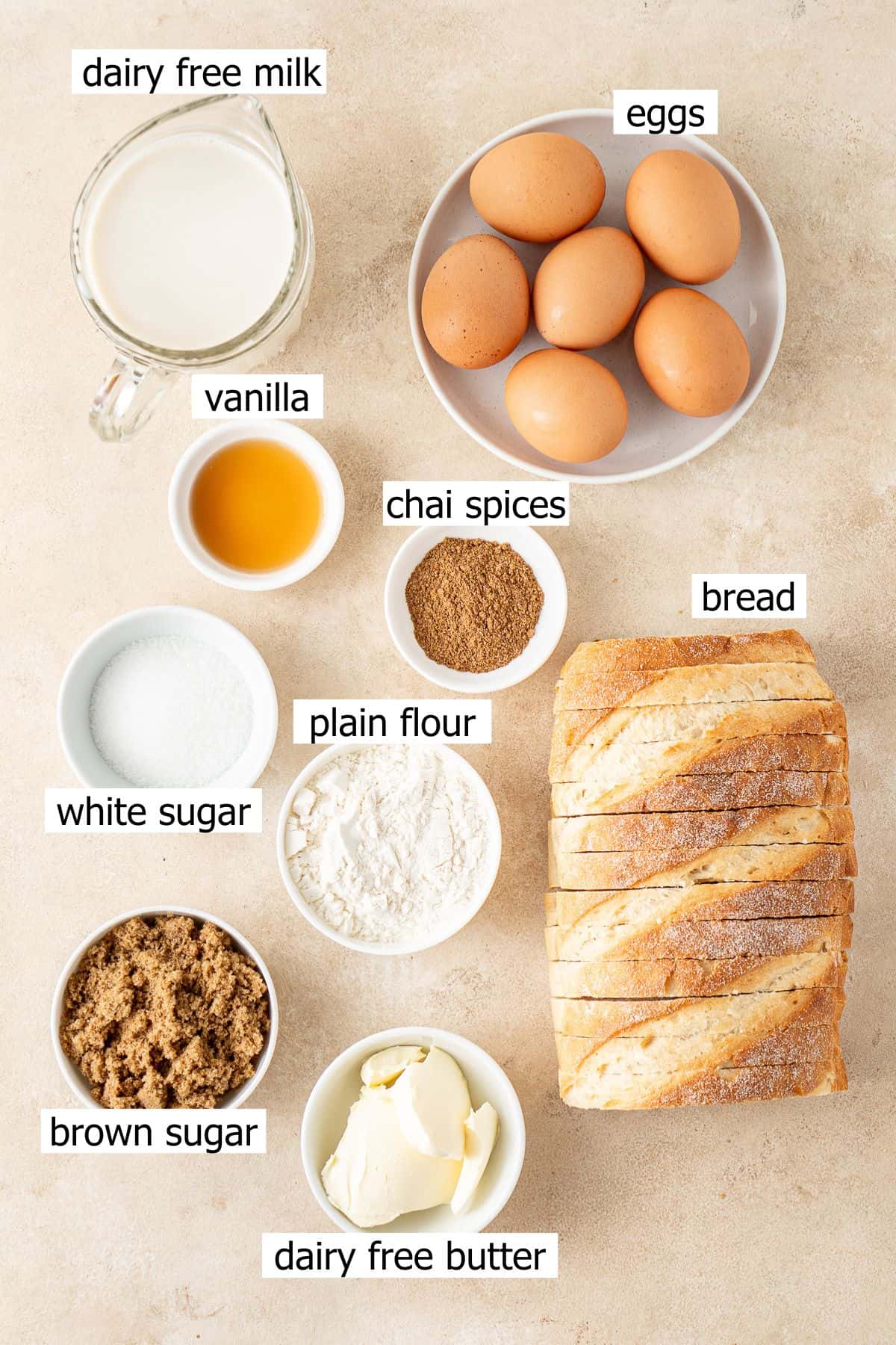 All ingredients needed to make dairy free French toast casserole laid out in small bowls.