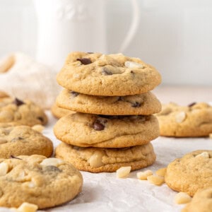 A stack of 4 dark chocolate macadamia cookies.