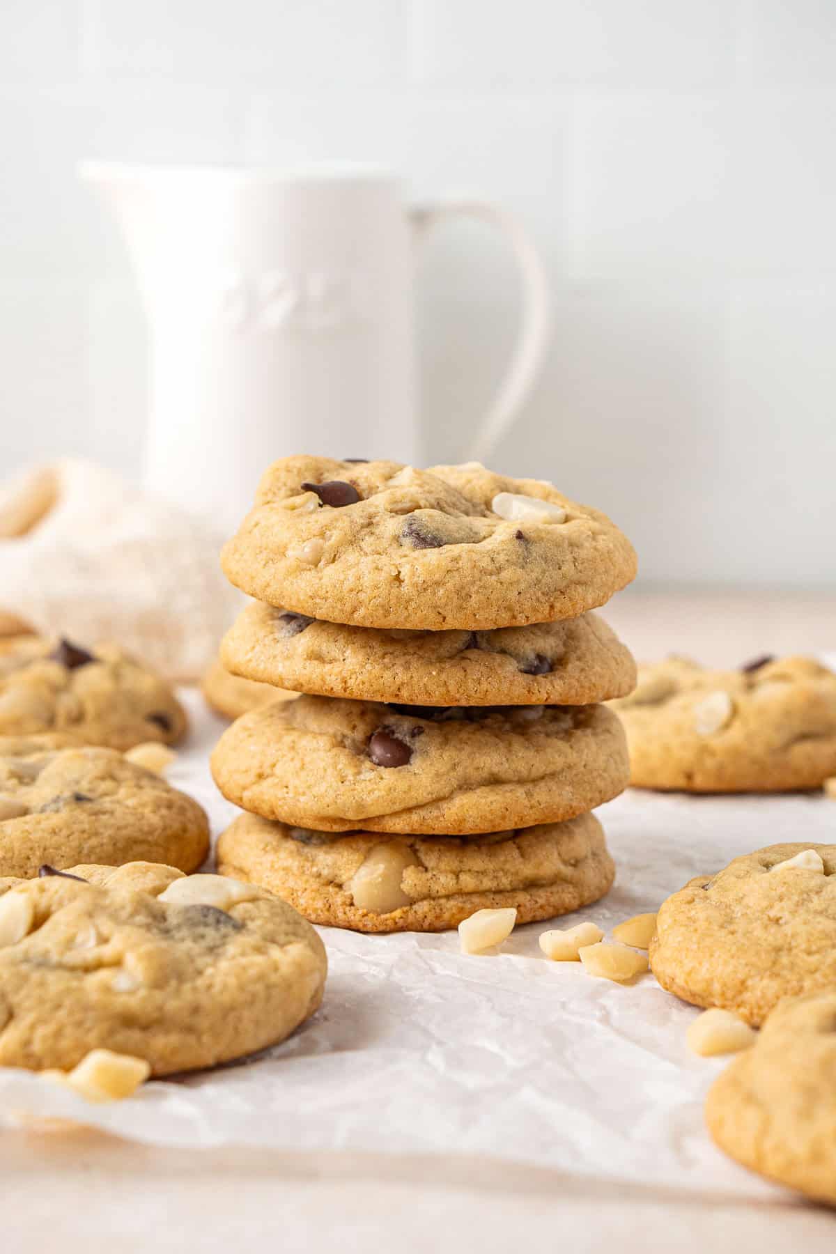 A stack of 4 dark chocolate macadamia cookies.