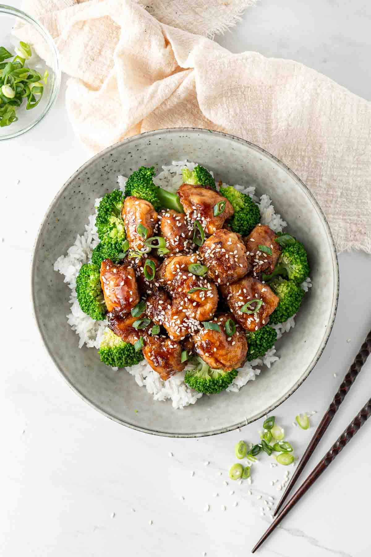 Overhead of a bowl of honey soy chicken with broccoli and rice.