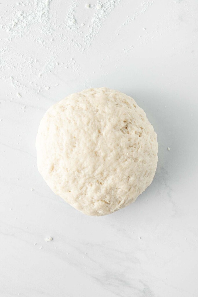 Dough kneaded on a kitchen surface.