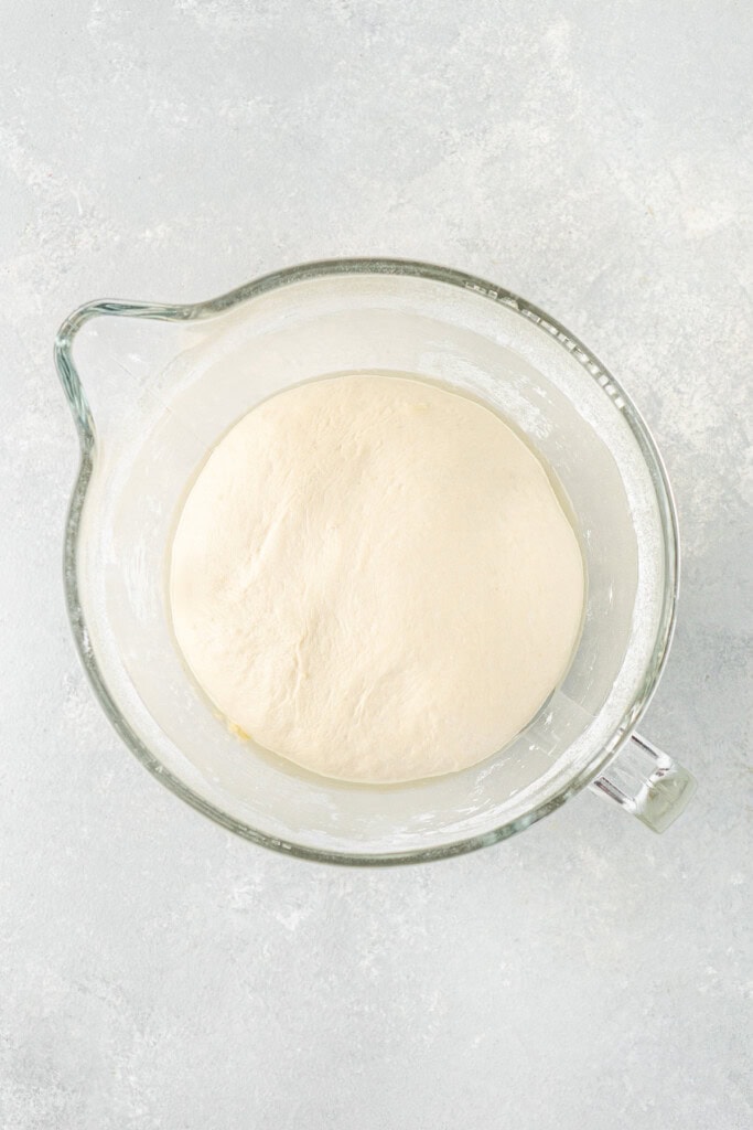 The risen dough in a bowl.