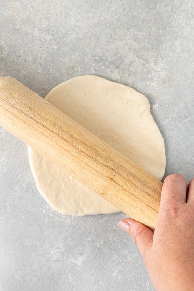 Rolling out the pita dough.