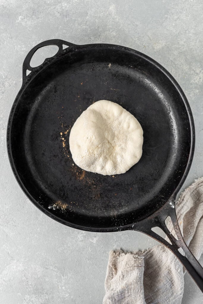 Cooking the pita in a dry cast iron pan.