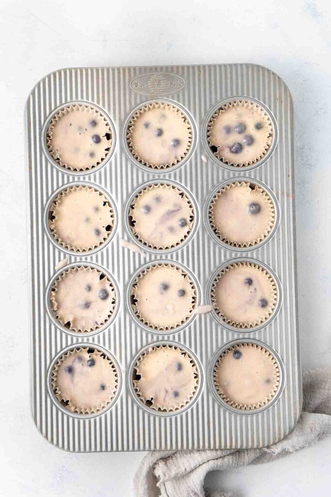 Muffin batter in a muffin pan.