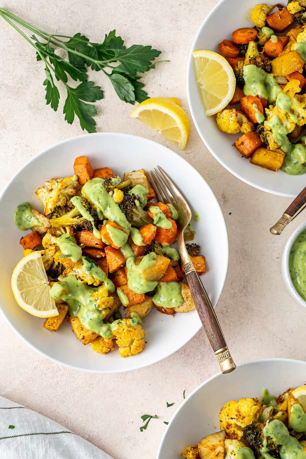 Roasted vegetable bowls with green goddess sauce.