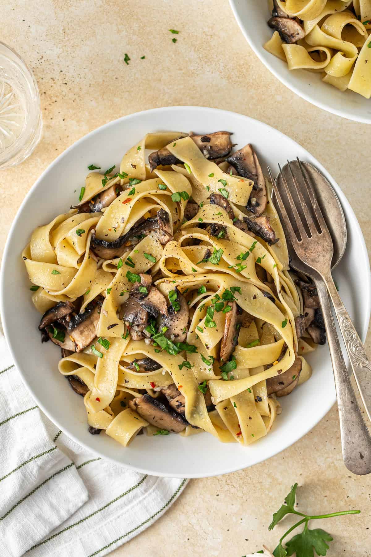 A bowl of mushroom pasta with a fork.