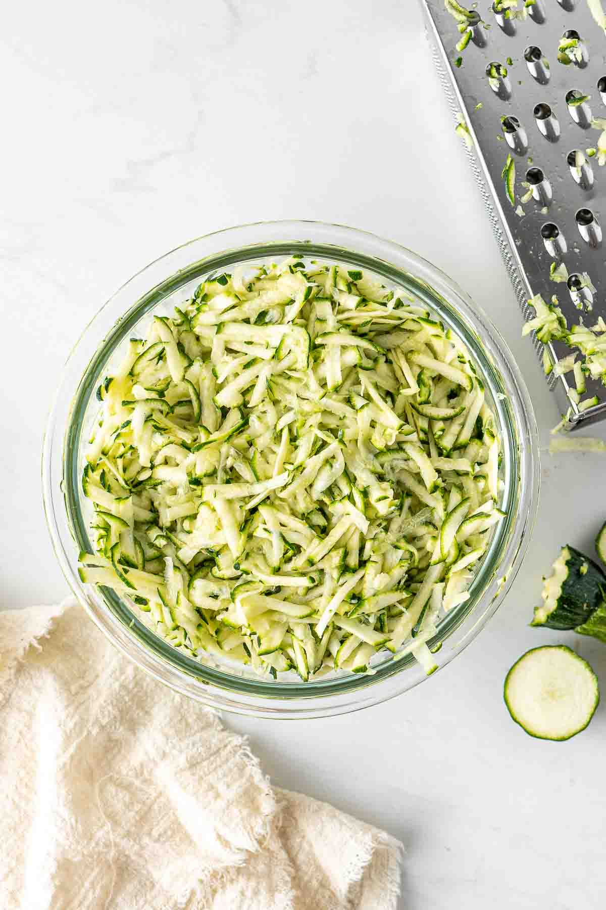 Grated zucchini in a bowl.