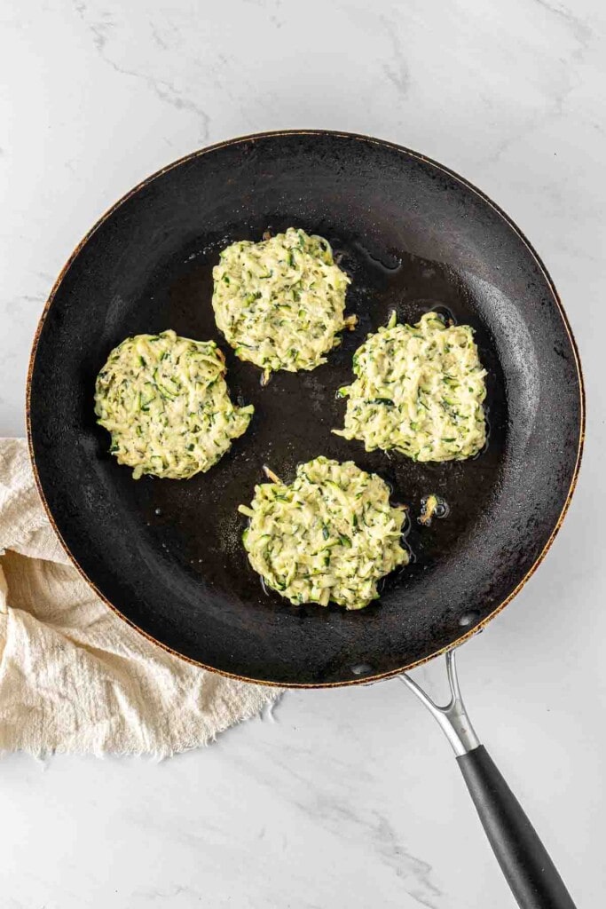 Fritters in a pan cooking.