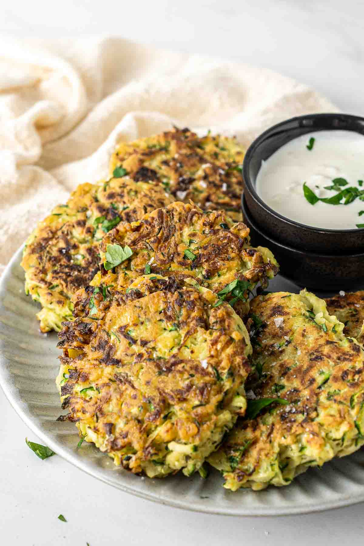Close up of crispy zucchini fritters on a plate.