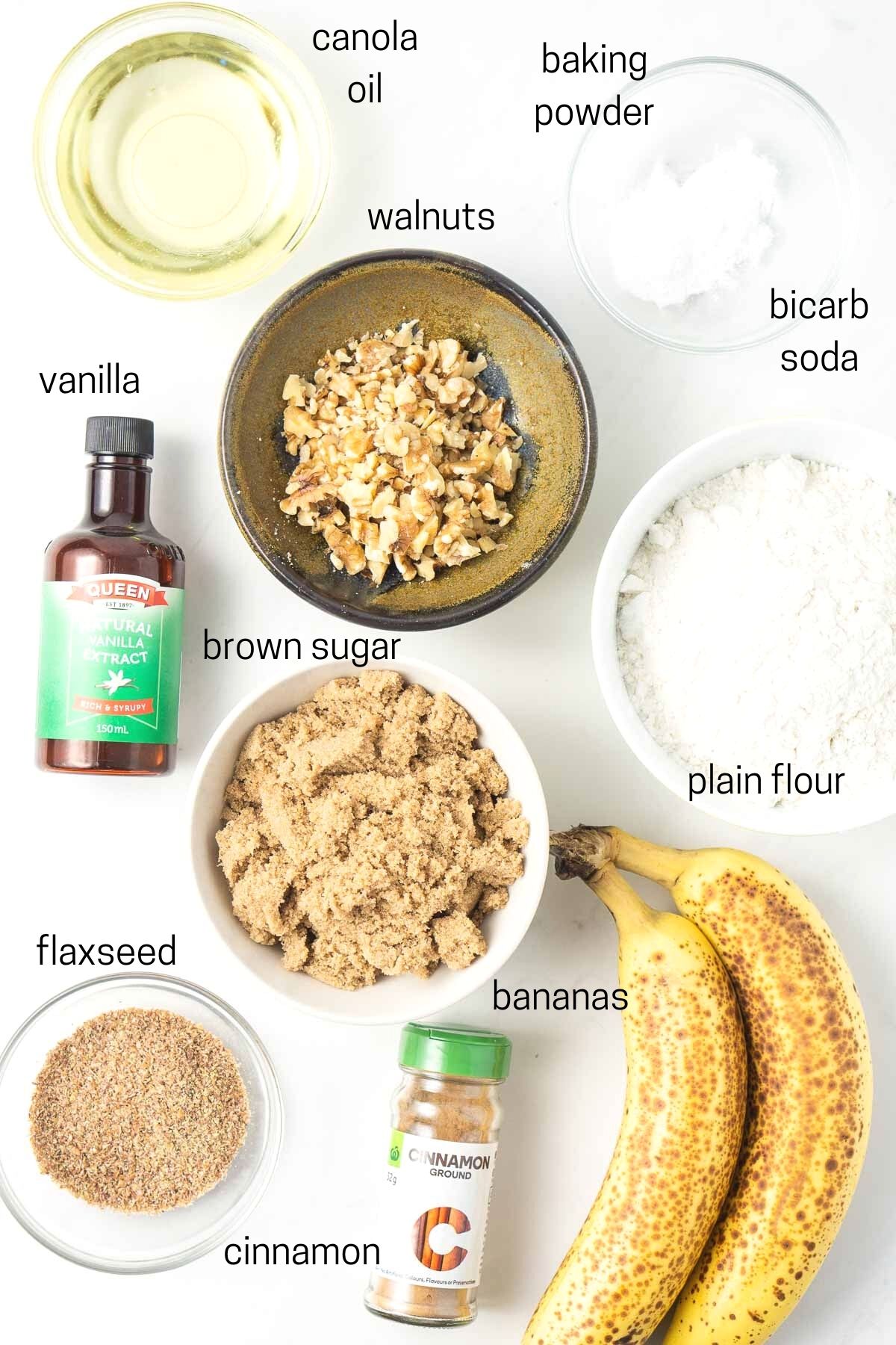 All ingredients needed to make vegan banana bread laid out in small bowls.