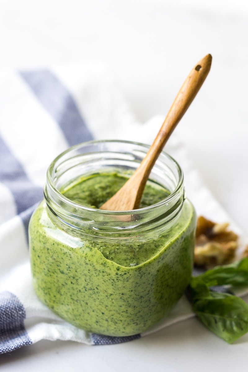 vegan basil pesto in a jar with a spoon