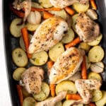 The cooked chicken and vegetables in a baking tray.