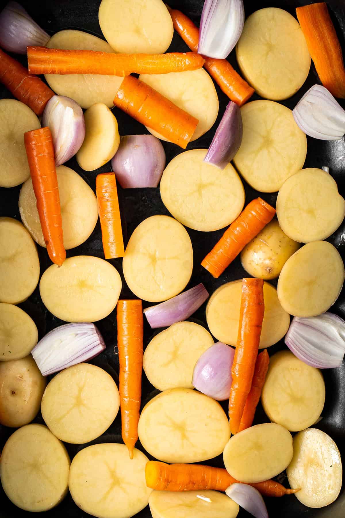 The cut vegetables laid into a baking tray.
