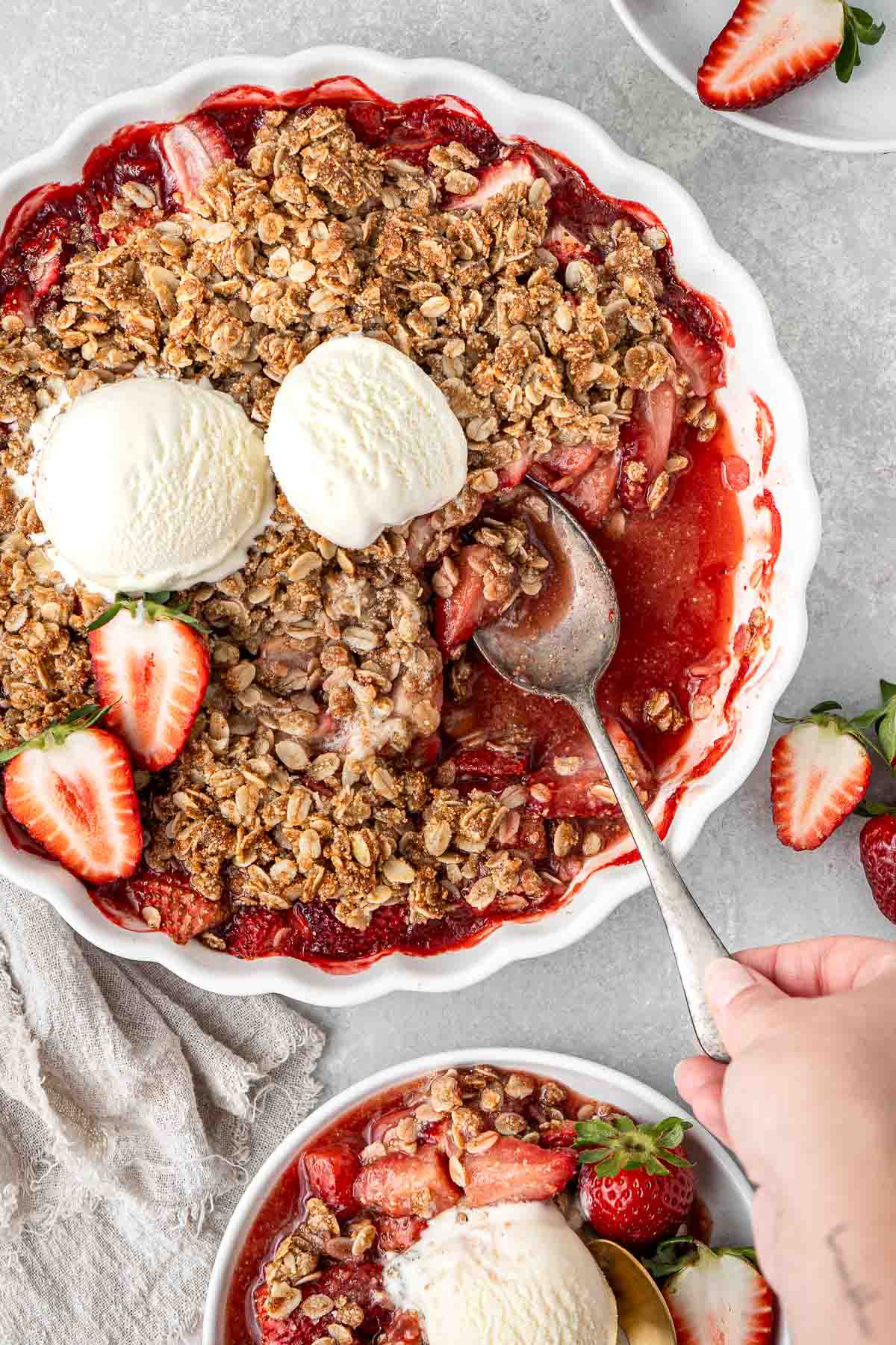 Serving up the strawberry crumble onto plates.