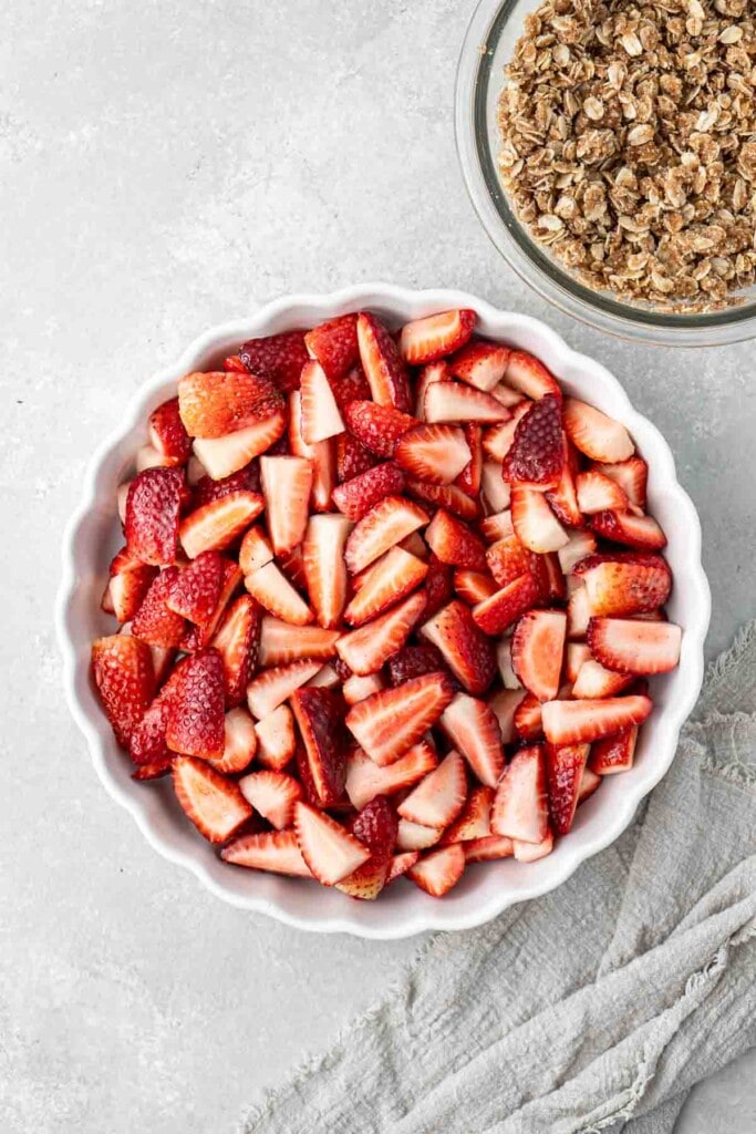 Chopped strawberries in a round baking dish.