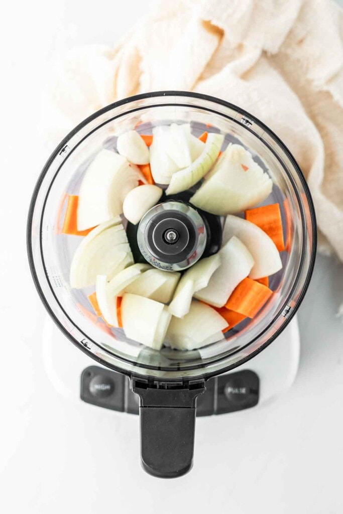 Onion and carrot in a food processor. 