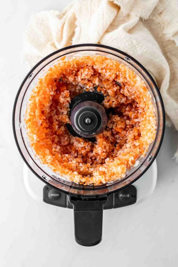 Onion, carrot and bacon mixture in a food processor. 