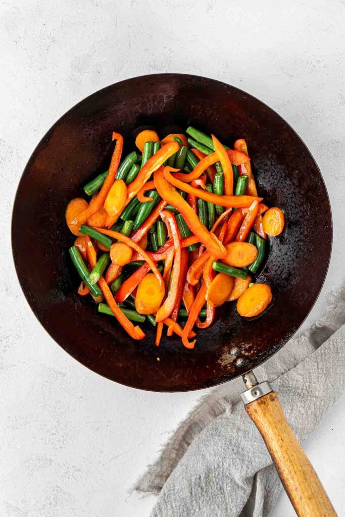 Stir frying vegetables in a wok.