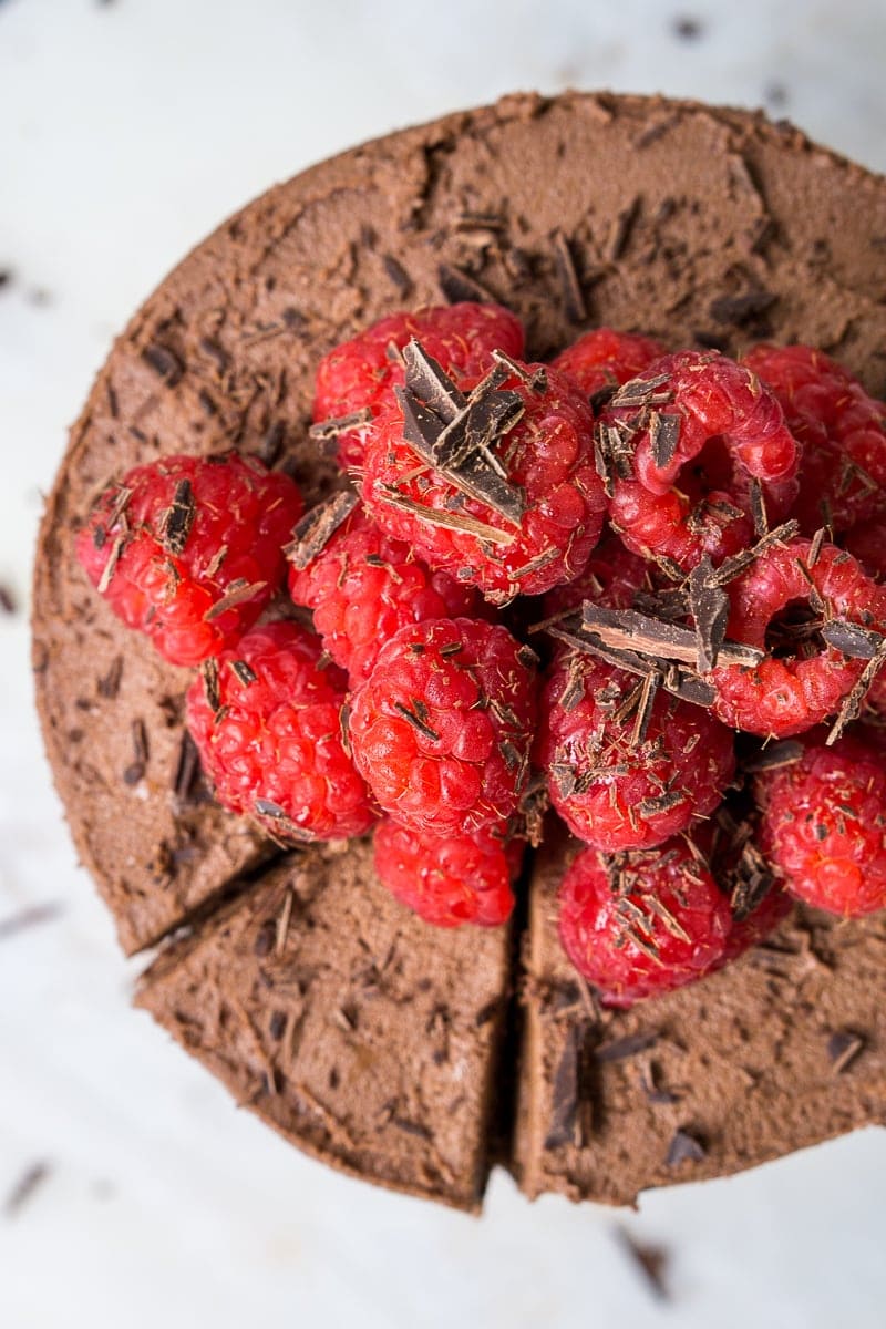 Top down of chocolate cake topped with fresh raspberries