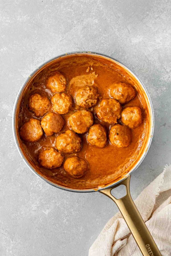 Cooked curry sauce with baked chicken meatballs.
