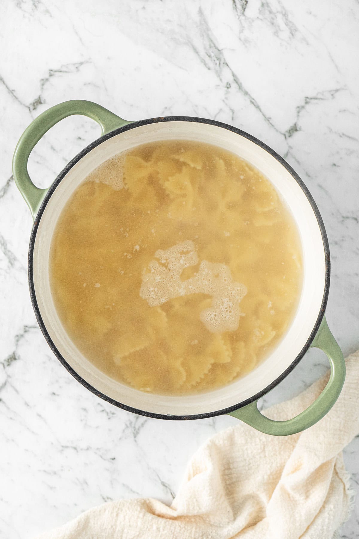 The pasta cooking in water.