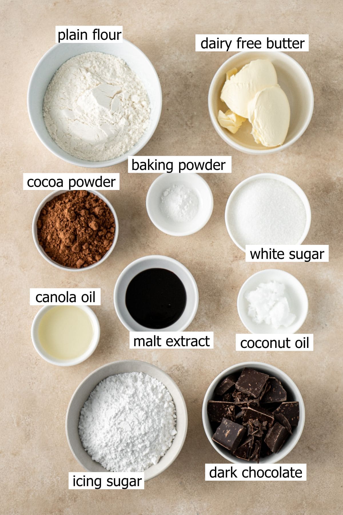 All ingredients needed to make vegan Tim Tams laid out in small bowls.