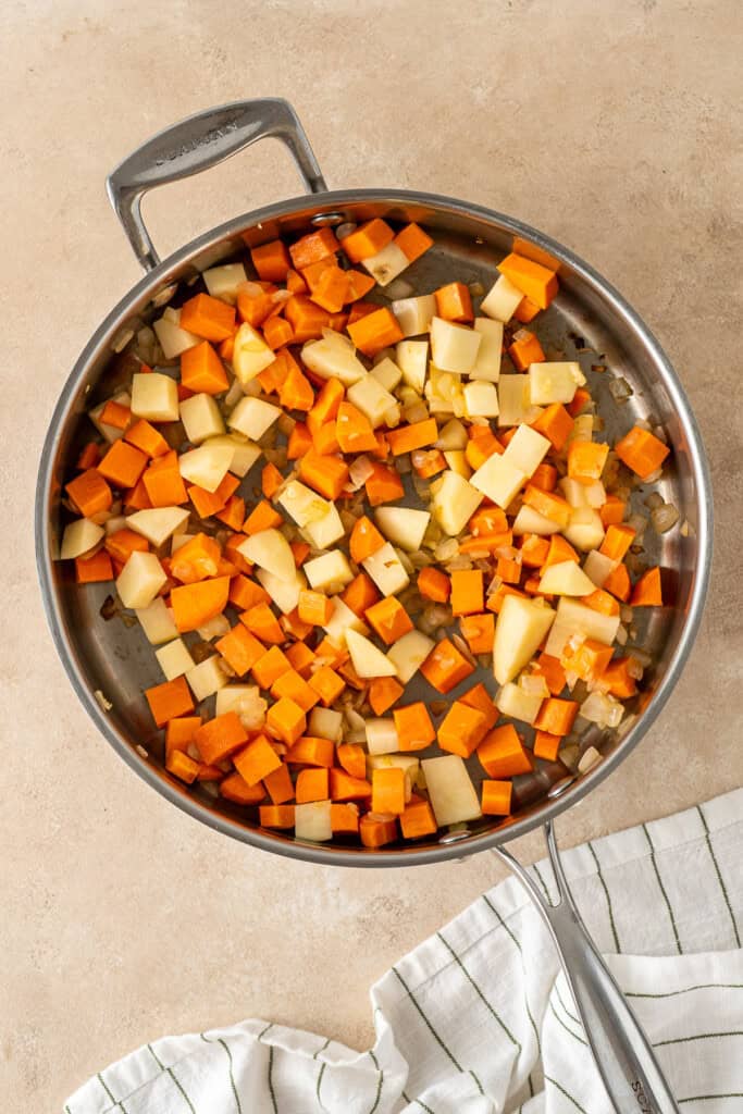 The diced vegetables in a frying pan.