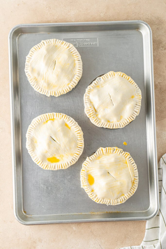The pies ready for the oven on a baking tray.