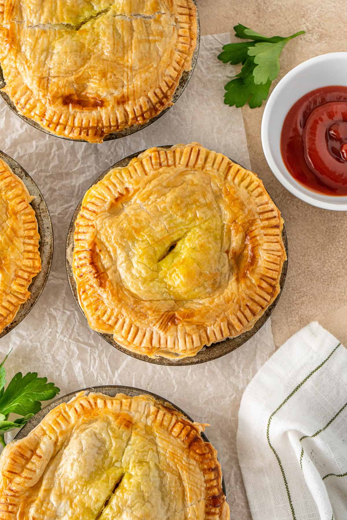Close up of baked curry pies in pie tins.
